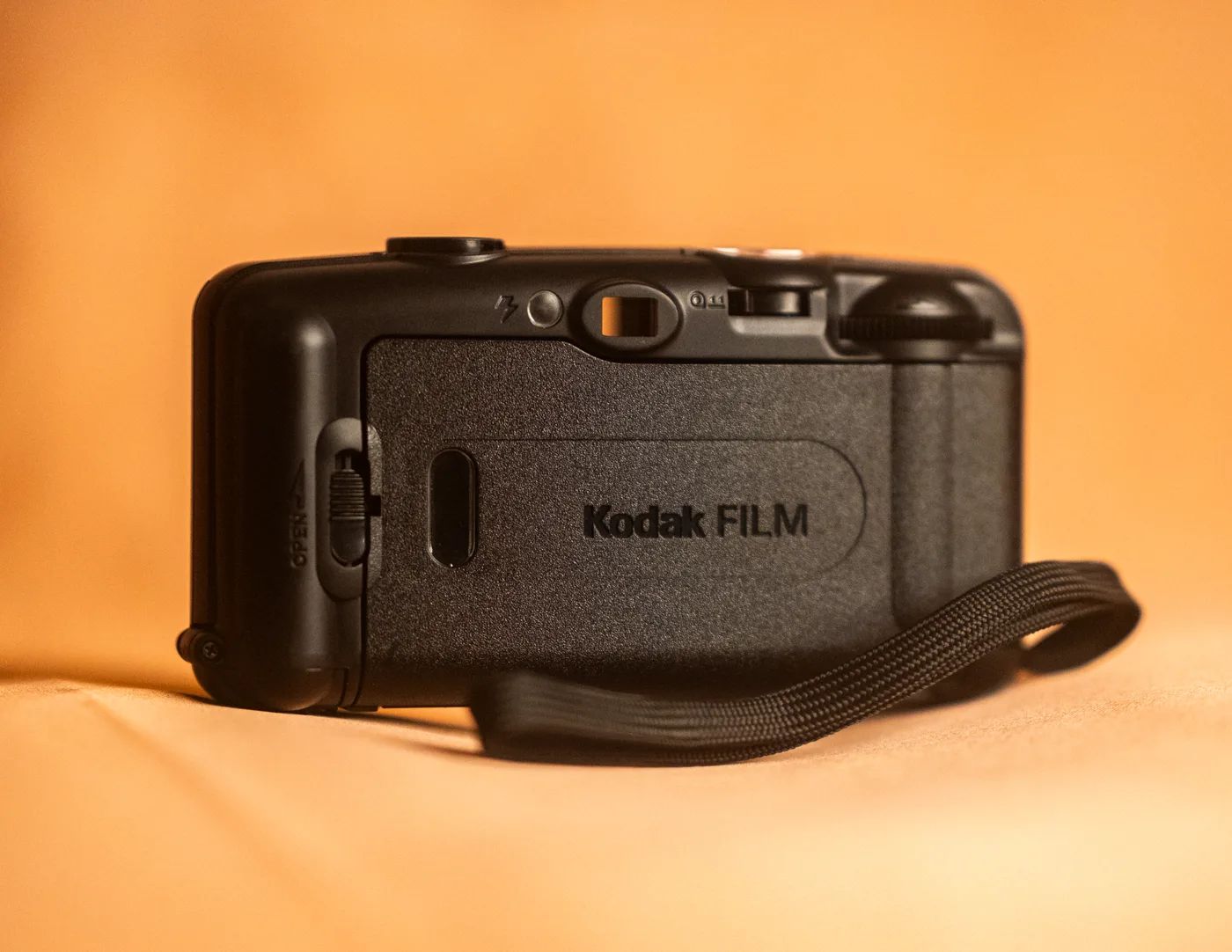 The back of the camera, showing the film door marked Kodak FILM, the viewfinder and the flash button.